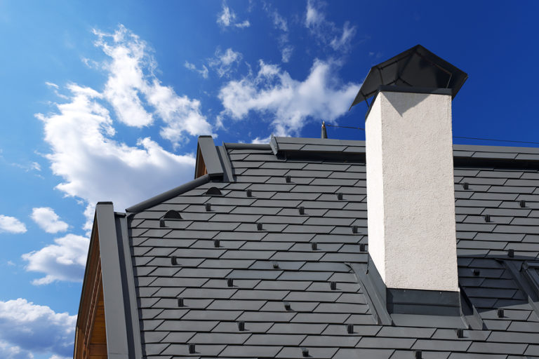dark gray metal roofing with white chimney on Lansing, MI, home