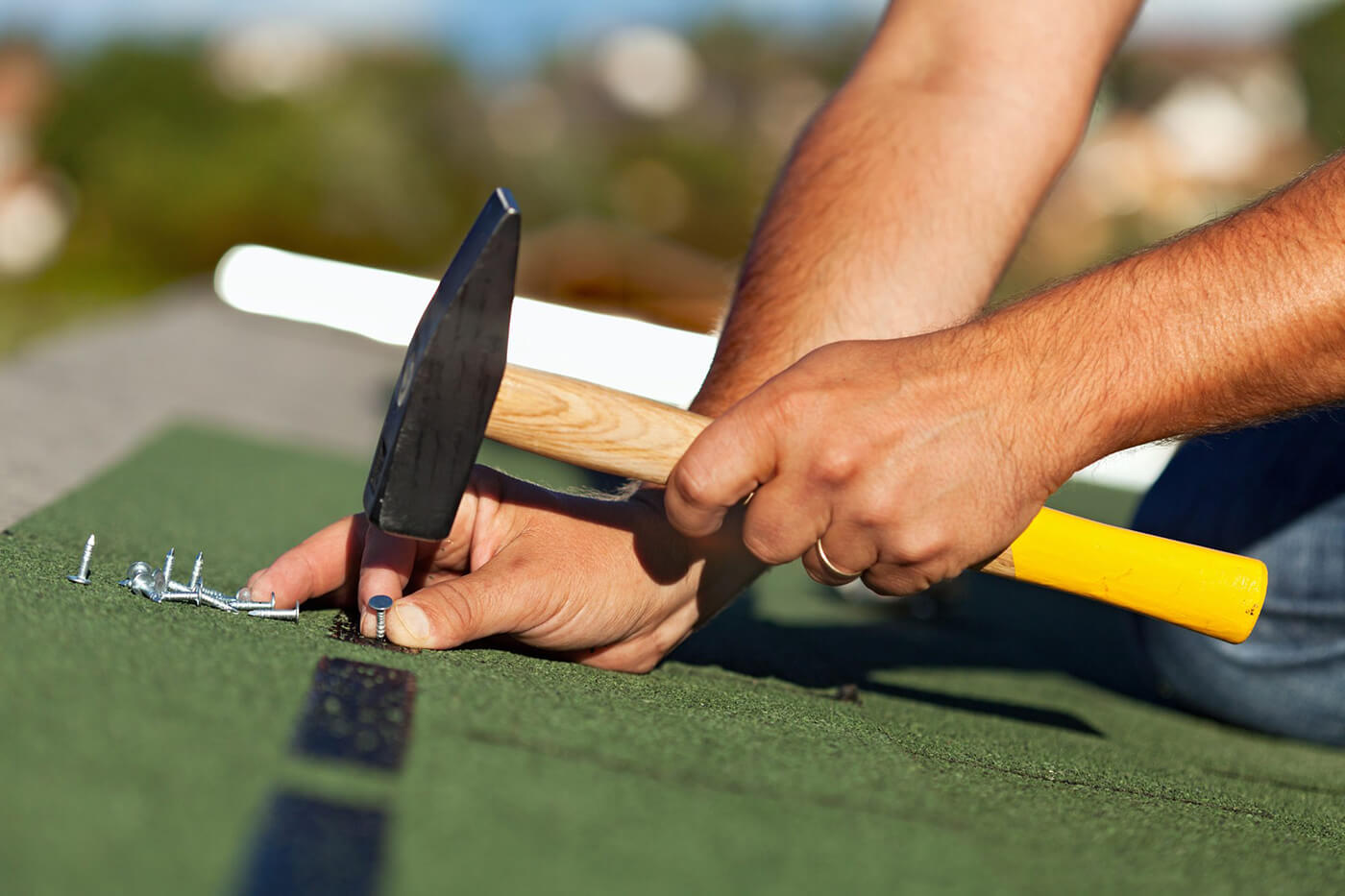 Hands with Hammer for Roofing in Saginaw, Midland, MI, Lansing, Bay City, Mount Pleasant, MI
