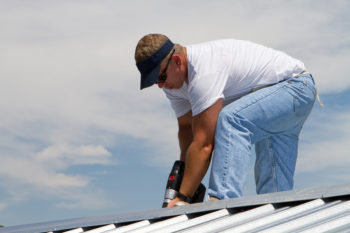 Roofer Working with Tools for Steel Roofing in Lansing, Saginaw, Bay City, Midland, MI, Mount Pleasant